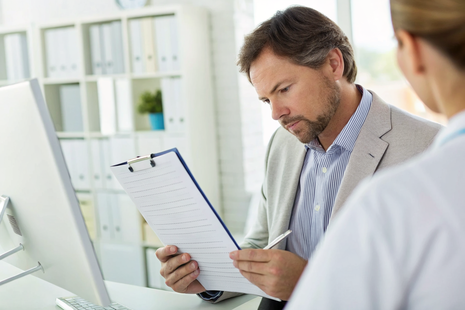 Consultant reviewing DHA documents with a checklist.